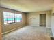 Bright living room featuring carpet floors, a closet, and a large window that provides natural light at 500 Newell Hill Rd # D, Leesburg, FL 34748