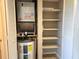 The utility closet features an updated water heater and HVAC system, with additional shelving for extra storage space at 500 Newell Hill Rd # D, Leesburg, FL 34748