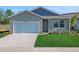 Charming single-Gathering home featuring a well-manicured lawn and attached two-car garage, offering suburban appeal at 5027 Abigail Dr, Lake Wales, FL 33859