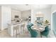 Open-concept kitchen and dining area featuring modern appliances, an island, and ample seating at 5027 Abigail Dr, Lake Wales, FL 33859
