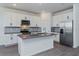 Modern kitchen featuring stainless steel appliances, an island with sink, and white cabinets at 5031 Abigail Dr, Lake Wales, FL 33859