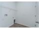 The functional laundry room includes tile floors, shelving, and utility hook ups at 5031 Abigail Dr, Lake Wales, FL 33859
