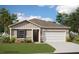 Charming one-story home with a two-car garage, stone accents, neutral colors, and a well-manicured lawn at 5035 Abigail Dr, Lake Wales, FL 33859