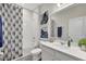 A stylish bathroom is designed with modern fixtures, elegant decor, and a shower featuring an attractive shower curtain at 5039 Abigail Dr, Lake Wales, FL 33859