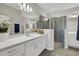 Modern bathroom featuring dual sinks, a large mirror, and a walk-in shower with glass doors at 5039 Abigail Dr, Lake Wales, FL 33859