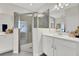 Bathroom featuring separate sink vanities and a walk-in shower with modern grey tile at 5039 Abigail Dr, Lake Wales, FL 33859