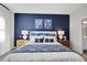 Comfortable bedroom with a blue accent wall, side tables, lamps, and artwork at 5039 Abigail Dr, Lake Wales, FL 33859