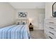 An inviting bedroom features a beautifully made bed with blue and white striped bedding and decorative wall art at 5039 Abigail Dr, Lake Wales, FL 33859