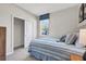 A cozy bedroom offers a comfortable bed, natural light, and a well-organized closet for a functional living space at 5039 Abigail Dr, Lake Wales, FL 33859