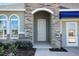 Inviting front entryway with a stone archway and a classic, paneled front door at 5039 Abigail Dr, Lake Wales, FL 33859