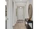 Light and airy hallway with hardwood floors, decorative mirror, and stylish console table at 5039 Abigail Dr, Lake Wales, FL 33859