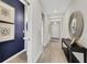 Elegant hallway featuring blue accent wall, stylish mirror, and console table at 5039 Abigail Dr, Lake Wales, FL 33859