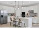Close up view of a kitchen island featuring modern appliances, pendant lights, and three stools at 5039 Abigail Dr, Lake Wales, FL 33859