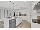 Well-equipped kitchen island featuring stainless steel appliances, a sink, dishwasher, and white countertops at 5039 Abigail Dr, Lake Wales, FL 33859