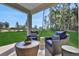 Comfortable covered patio area with stylish outdoor seating and a view of the expansive yard at 5039 Abigail Dr, Lake Wales, FL 33859