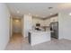 Modern kitchen with white cabinets, stainless steel appliances and a large island at 5043 Abigail Dr, Lake Wales, FL 33859