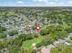 Aerial view of a charming neighborhood surrounded by lush greenery and a golf course at 511 Chula Vista Ave, The Villages, FL 32159