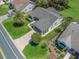Expansive aerial shot of a home with lush landscaping and a patterned driveway at 511 Chula Vista Ave, The Villages, FL 32159