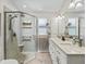 Modern bathroom with a glass-enclosed shower, double vanity, and contemporary fixtures at 511 Chula Vista Ave, The Villages, FL 32159