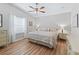 Bright bedroom with a large window, wood floors, and neutral tones, offering a peaceful retreat at 511 Chula Vista Ave, The Villages, FL 32159