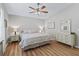 Comfortable bedroom with wood floors, light walls, a ceiling fan, and coordinated décor at 511 Chula Vista Ave, The Villages, FL 32159