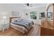 Comfortable bedroom with natural light, ceiling fan, and wood laminate flooring at 511 Chula Vista Ave, The Villages, FL 32159