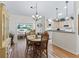 Cozy dining area with wood table, chandelier, and view into the living room and kitchen at 511 Chula Vista Ave, The Villages, FL 32159
