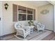 Welcoming front porch features cozy rocking chairs and a quaint table setting at 511 Chula Vista Ave, The Villages, FL 32159