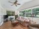 Bright living room featuring vaulted ceilings, large windows, and comfortable seating at 511 Chula Vista Ave, The Villages, FL 32159