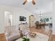 Comfortable living area with hardwood floors, large TV, and view into the dining space at 511 Chula Vista Ave, The Villages, FL 32159