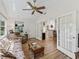 Cozy living room with wood flooring, natural light, and open access to kitchen at 511 Chula Vista Ave, The Villages, FL 32159