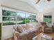 A sunlit living room with a large window offering views of the manicured outdoors at 511 Chula Vista Ave, The Villages, FL 32159