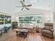 Well-lit living room boasts vaulted ceiling, large windows overlooking landscaped yard, and neutral tones at 511 Chula Vista Ave, The Villages, FL 32159