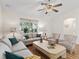 Bright and airy living room featuring hardwood floors, a large window, and comfortable seating at 511 Chula Vista Ave, The Villages, FL 32159