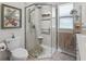 Updated bathroom with a corner glass shower with a seat, rainfall shower head, and a tiled floor at 511 Chula Vista Ave, The Villages, FL 32159