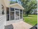 Enclosed sunroom with screened windows overlooking the home's landscaping and surrounding greenery at 511 Chula Vista Ave, The Villages, FL 32159