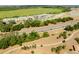 An aerial shot shows homes near a park, highway, and wooded area, offering a blend of convenience and nature at 5325 Zisa Ct, The Villages, FL 32163