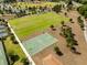 Aerial view showcases community amenities including a basketball court, sports field, and walking path at 5325 Zisa Ct, The Villages, FL 32163