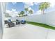 Lovely backyard featuring a patio with seating around a fire pit and well-kept lawn at 5325 Zisa Ct, The Villages, FL 32163