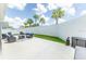 Inviting backyard with patio seating, fire pit, manicured lawn, and tall privacy fence at 5325 Zisa Ct, The Villages, FL 32163