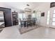Elegant dining area with stylish table setting, modern lighting, and bright natural light at 5325 Zisa Ct, The Villages, FL 32163