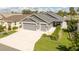 Charming home featuring a spacious driveway, a two-car garage, and well-maintained landscaping at 5325 Zisa Ct, The Villages, FL 32163