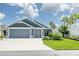 Charming single story home featuring a two-car garage, landscaped yard, and welcoming curb appeal at 5325 Zisa Ct, The Villages, FL 32163