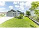 Single-Gathering home featuring a well-maintained front yard, enhanced by lush green grass at 5325 Zisa Ct, The Villages, FL 32163