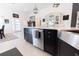Bright kitchen featuring black cabinets, stainless steel appliances and a farmhouse style sink at 5325 Zisa Ct, The Villages, FL 32163