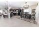 Open-concept kitchen and dining area featuring modern appliances, stylish lighting, and ample counter space at 5325 Zisa Ct, The Villages, FL 32163