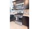 Kitchen features stainless steel oven and gray brick backsplash at 5325 Zisa Ct, The Villages, FL 32163