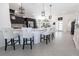 Bright kitchen featuring modern white countertop, bar stool seating, and modern appliances at 5325 Zisa Ct, The Villages, FL 32163