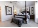Elegant primary bedroom with a four-poster bed and stylish decor at 5325 Zisa Ct, The Villages, FL 32163
