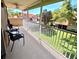 Outdoor seating on the balcony with a view of lush landscaping at 5373 Compass Pt # 1, Oxford, FL 34484